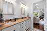 Full bath with ornamental molding, double vanity, recessed lighting, and light tile patterned flooring