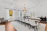 Dining space featuring a decorative wall, beam ceiling, a wainscoted wall, a chandelier, and wood finished floors