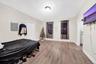 Bedroom with electric panel and light wood finished floors