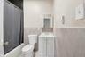 Bathroom with wainscoting, vanity, tile walls, and shower / bath combo