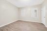 Bedroom featuring light wood-style flooring and baseboards