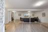 Living room featuring a baseboard heating unit and light wood-type flooring
