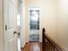 Doorway with baseboards and dark wood-style flooring