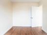 Empty room featuring wood finished floors and baseboards