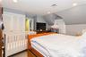 Bedroom with lofted ceiling, a closet, and light carpet