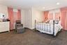 Carpeted bedroom with ornamental molding