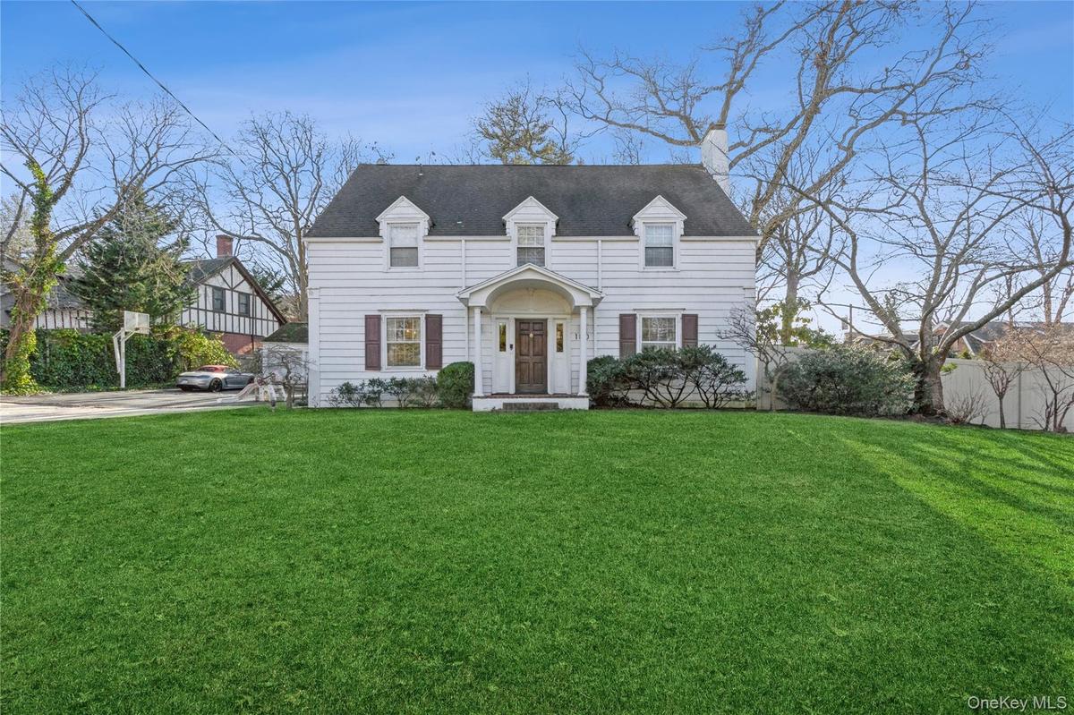 Cape cod-style house with a front lawn