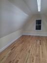 Bonus room featuring light wood-type flooring and vaulted ceiling