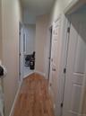 Corridor with light wood finished floors and baseboards