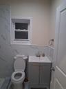 Full bath with tile walls and vanity