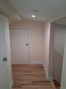 Hallway featuring light wood-style floors and baseboards