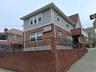 View of side of property featuring brick siding