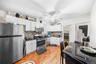 Kitchen with appliances with stainless steel finishes, decorative backsplash, and white cabinets