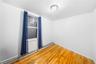 Empty room featuring a baseboard radiator and light wood finished floors