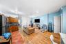 Living area with light wood-style flooring and recessed lighting