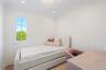 Bedroom with wallpapered walls and ornamental molding