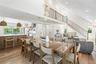 Dining room with recessed lighting, light wood-style floors, and a towering ceiling