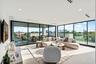 A breathtaking glass-wrapped sky lounge offering sweeping water and skyline views from nearly every angle. Bathed in natural light, this elevated retr