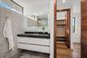 A sleek contemporary bath featuring a floating vanity with integrated lighting, minimalist hardware, and crisp modern finishes. Clean, bright, and tho