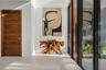A refined entry vignette showcasing a rich wood front door, sleek glass panels, and curated modern artwork that sets an elegant first impression. Clea