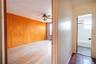 Corridor featuring light hardwood / wood-style floors, a wealth of natural light, and wooden walls