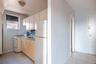 Kitchen featuring light tile patterned flooring, white appliances, and sink