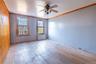 Unfurnished room with ceiling fan, radiator heating unit, crown molding, and light hardwood / wood-style flooring