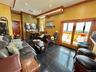 Living room with ornamental molding, recessed lighting, and granite floors