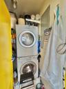 Washroom with stacked washer / drying machine