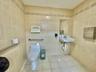 Half bathroom with tile walls and tile patterned flooring