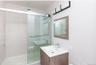 Bathroom featuring a stall shower and vanity