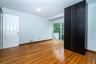 second bedroom featuring light hardwood flooring