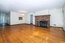 living room with recessed lighting, a fireplace, light hardwood flooring,