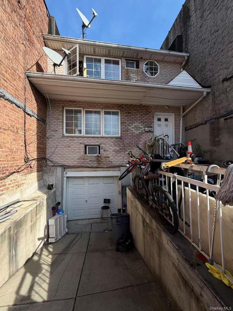 View of front facade with brick siding, a garage, and concrete driveway