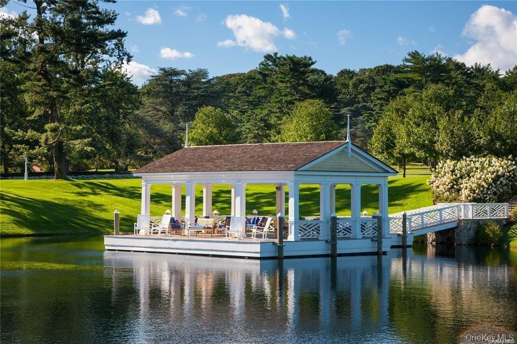 Dock featuring a water view and a yard