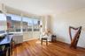 Living area featuring light wood-style floors and baseboards
