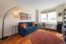 Living area featuring light wood finished floors and radiator