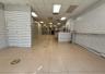 Hall with a drop ceiling and light tile patterned floors