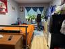 Bedroom with a wall mounted AC and light hardwood / wood-style flooring