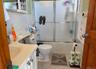 Full bathroom with vanity, tile patterned flooring, toilet, enclosed tub / shower combo, and tile walls