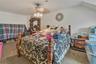 Carpeted bedroom with a ceiling fan