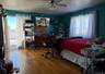 Bedroom featuring ceiling fan and hardwood / wood-style floors