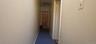 Hall with dark carpet and baseboards