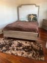 Bedroom featuring dark wood-style flooring and baseboards