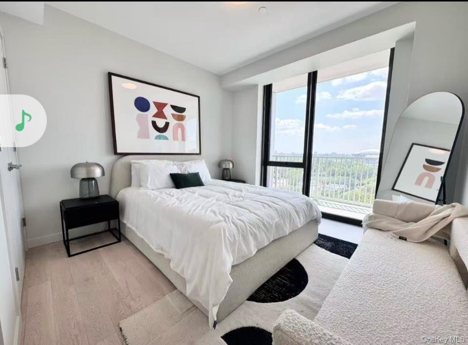 Bedroom with light wood-type flooring and baseboards