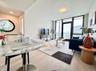 Living area with a wall of windows and wood finished floors