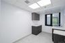 Bar area with dark brown cabinets, a drop ceiling, light stone counters, modern cabinets, and light tile patterned floors
