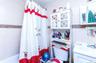 Full bathroom featuring tile walls, vanity, and shower / tub combo