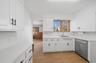 Stainless Steel appliances, New LVP flooring and modern black cabinet hardware