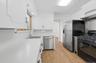 Stainless Steel appliances, modern black cabinet hardware, new LVP flooring